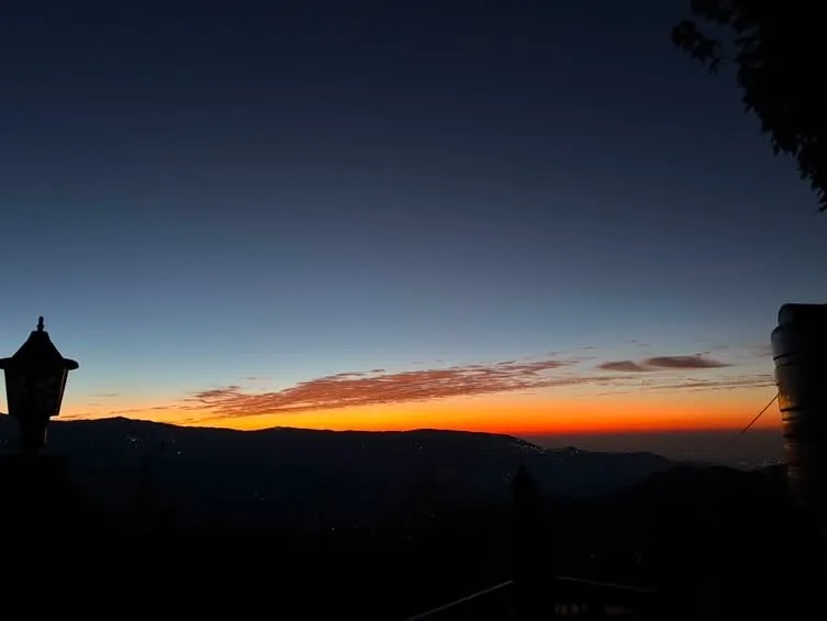 Dawn golden hour horizon with lantern silhouette at Zambala Dwelling Nest homestay